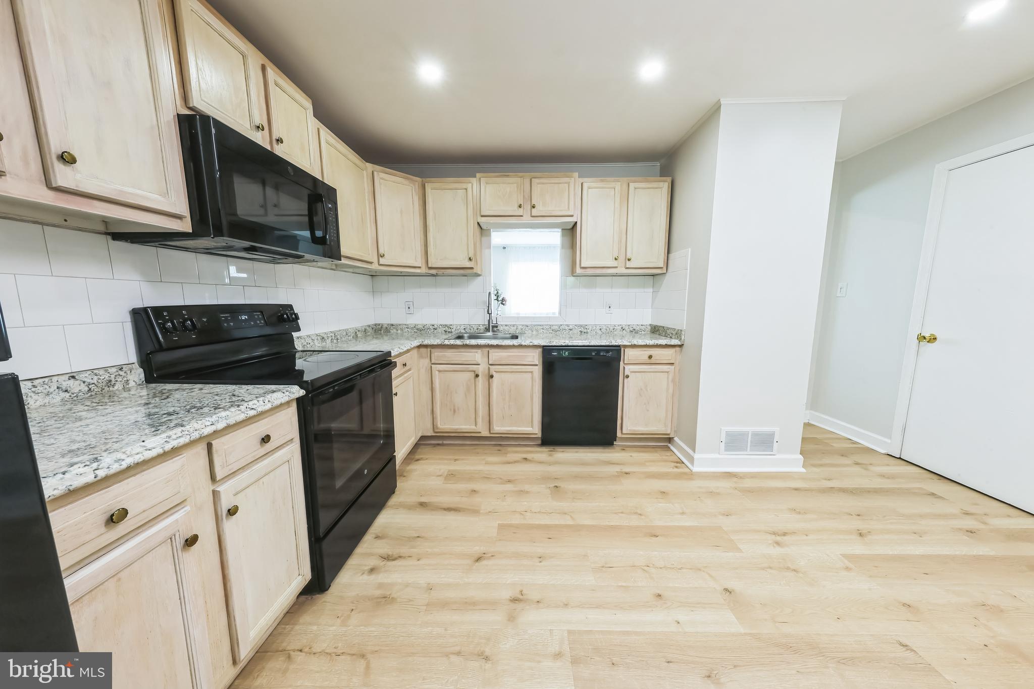 852 Hasting Court Newark, DE 19702 - Photo 10 of 29 a large kitchen with stainless steel appliances granite countertop a stove top oven a sink dishwasher and a microwave oven on the blue kitchen countertops