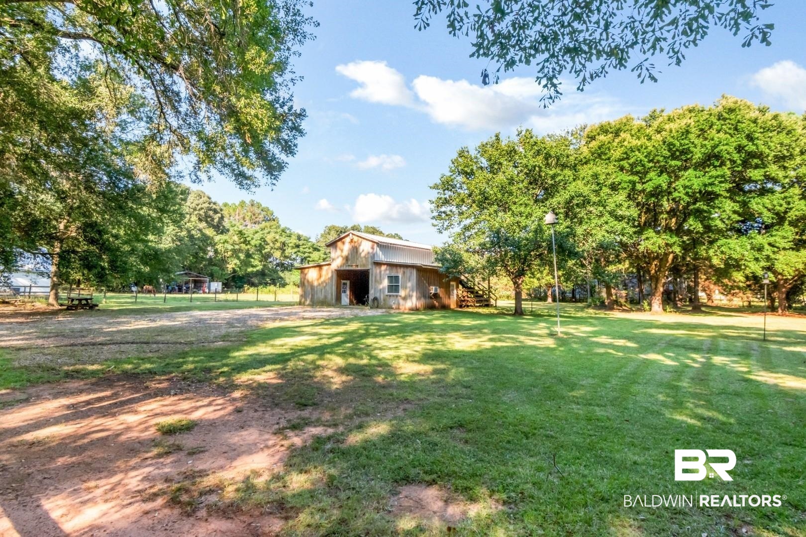 1360 Dykes Road North Mobile, AL 36608 - Photo 34 of 40 View of grassy yard featuring an outbuilding and a barn