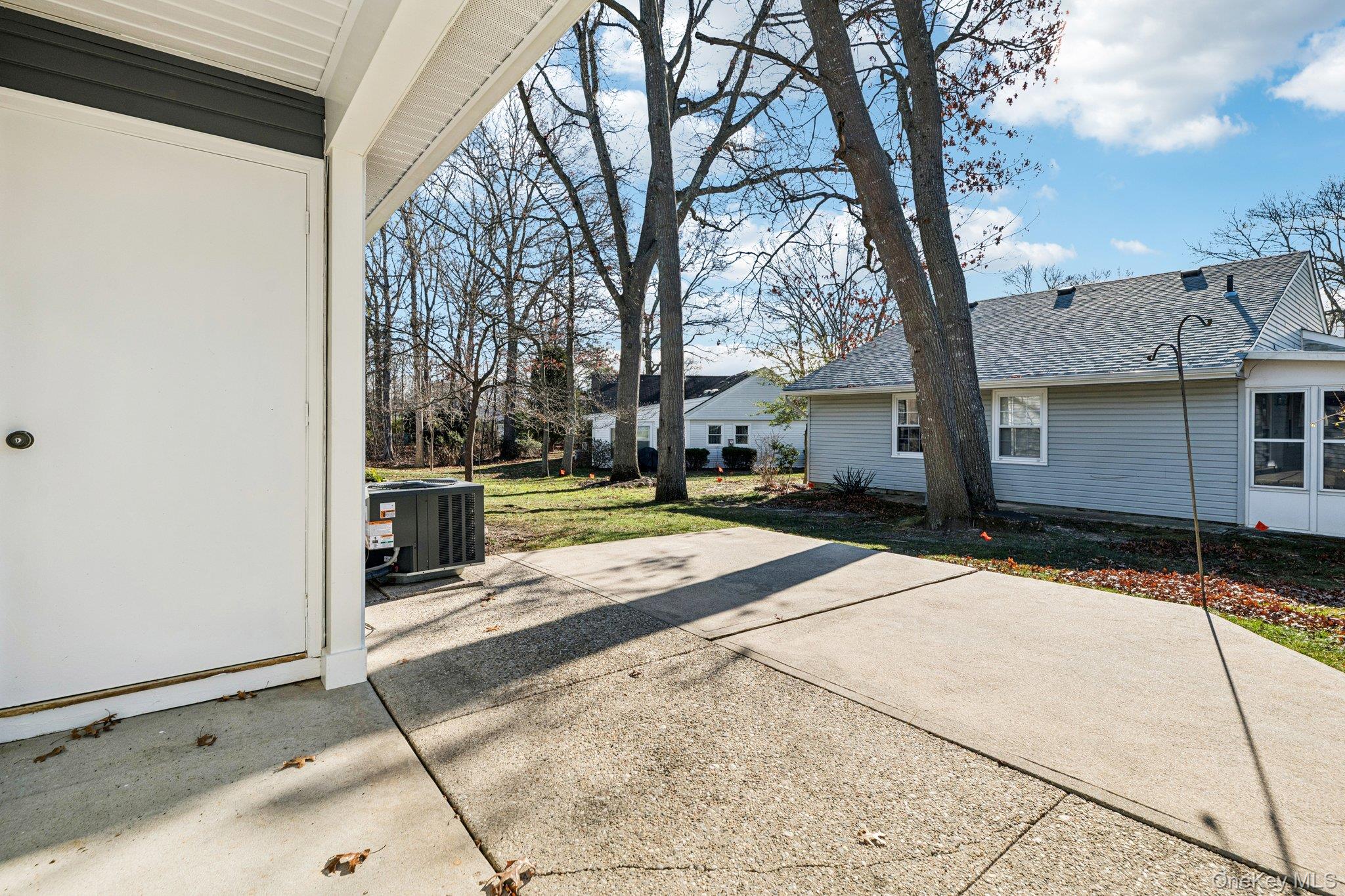 195 Canterbury Drive Ridge, NY 11961 - Photo 21 of 26 a view of a white house with a yard