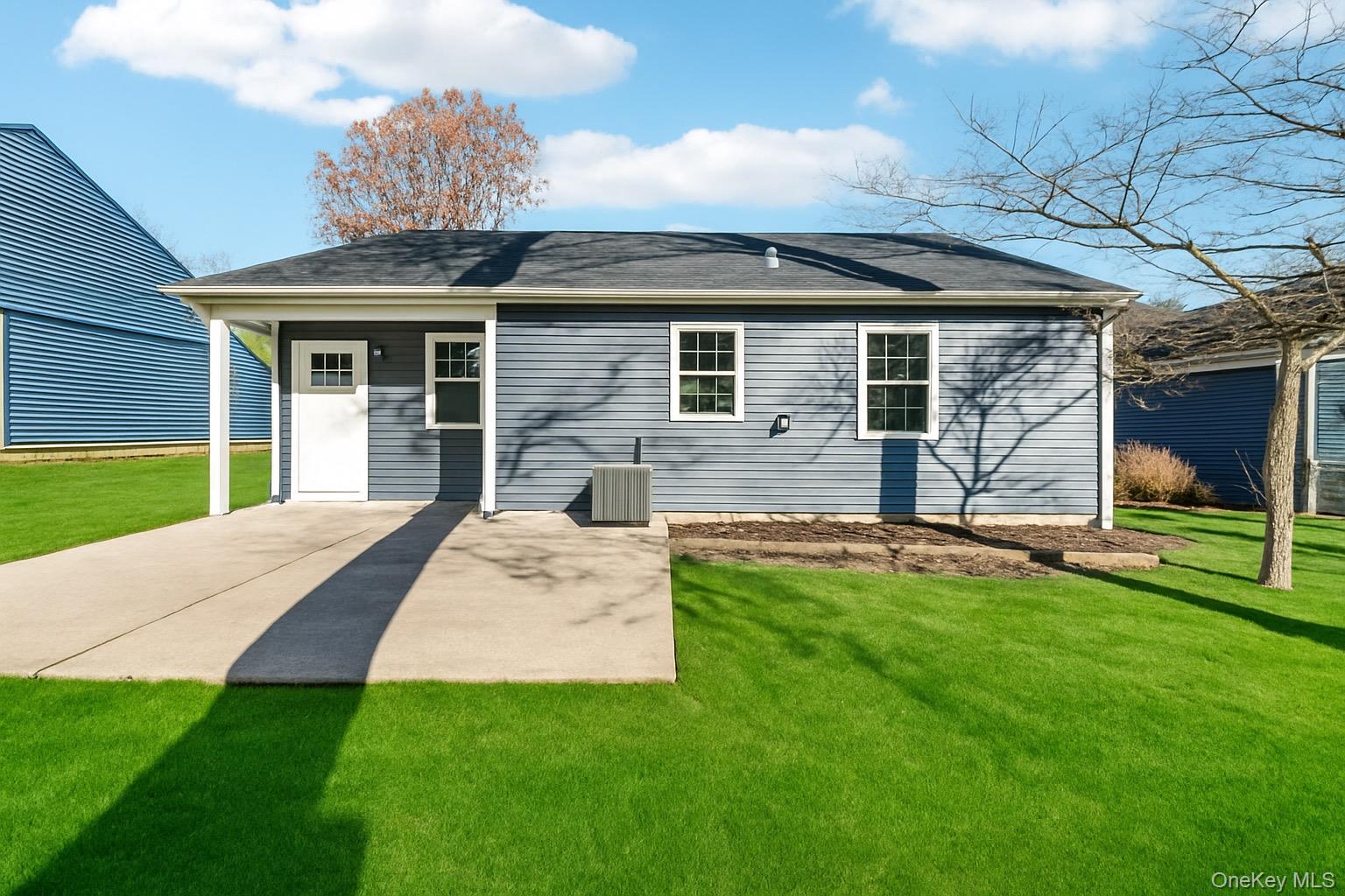 195 Canterbury Drive Ridge, NY 11961 - Photo 22 of 26 a view of a house with a yard and sitting area