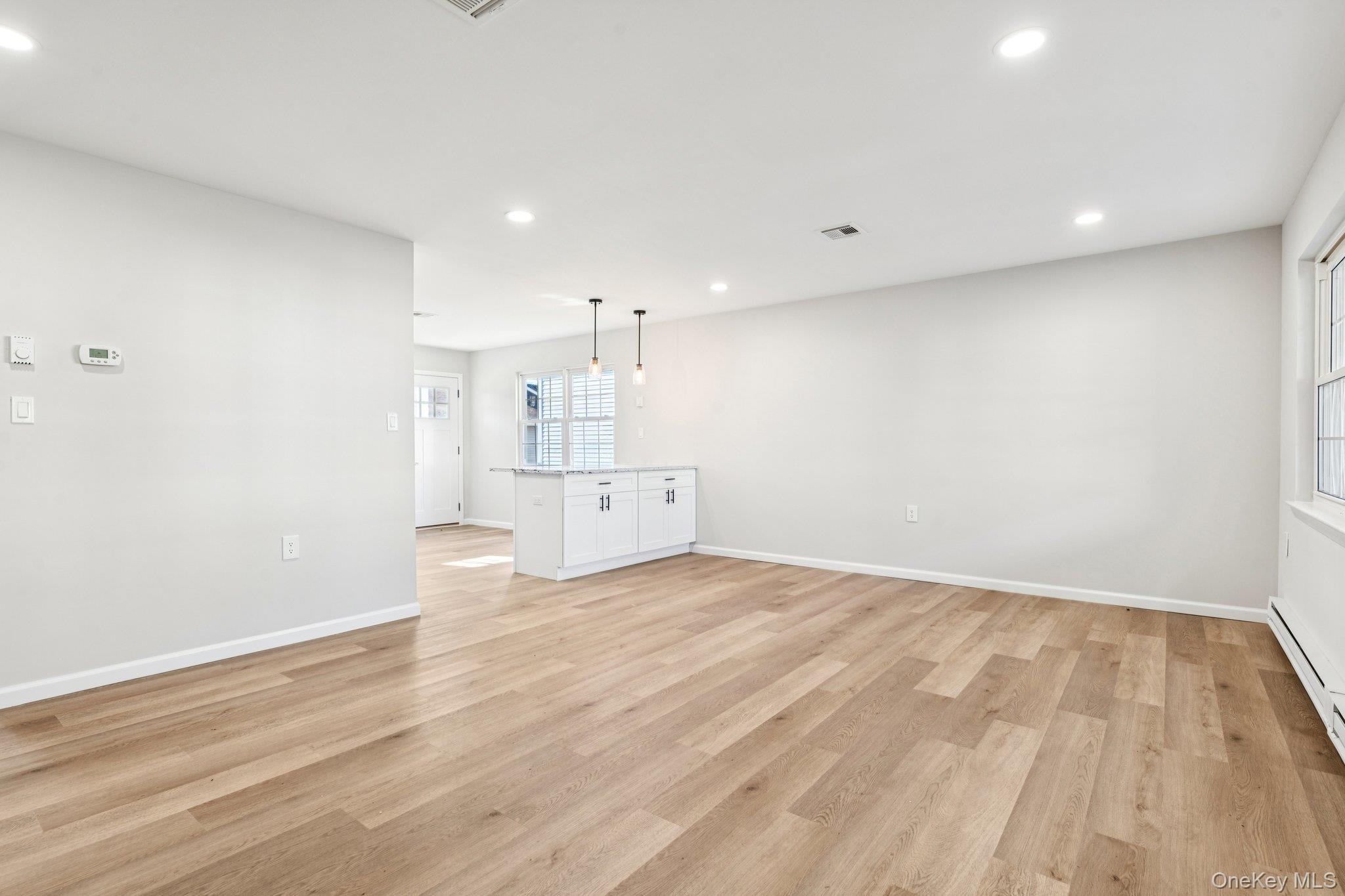 195 Canterbury Drive Ridge, NY 11961 - Photo 7 of 26 a view of empty room with wooden floor