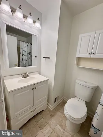 a bathroom with a sink toilet and mirror