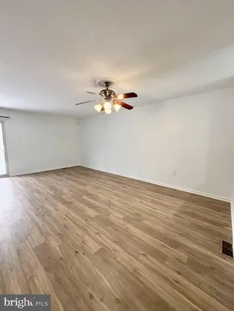 a view of a room with wooden floor