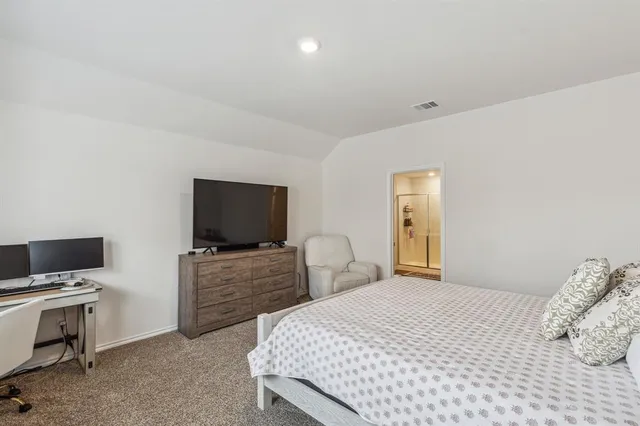 a bedroom with a bed and flat screen tv