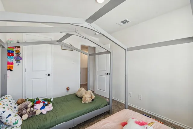 a bedroom with a bed and a dresser