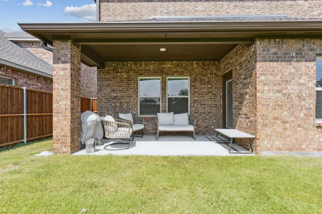 a front view of a house with outdoor seating