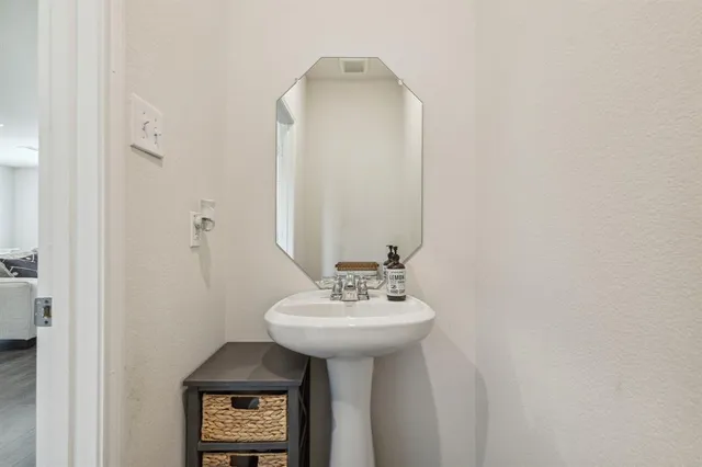 a bathroom with a sink a mirror and a shower