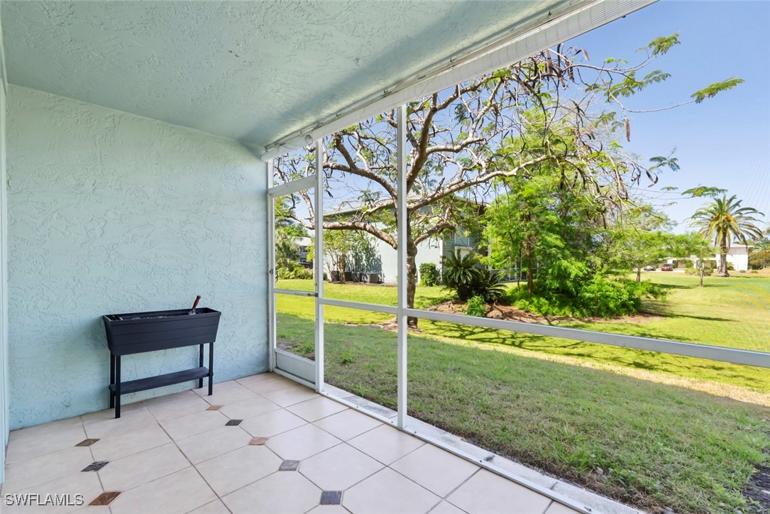 138 Cypress Way East, Unit 404 Naples, FL 34110 - Photo 16 of 32 a view of an outdoor space and a car park