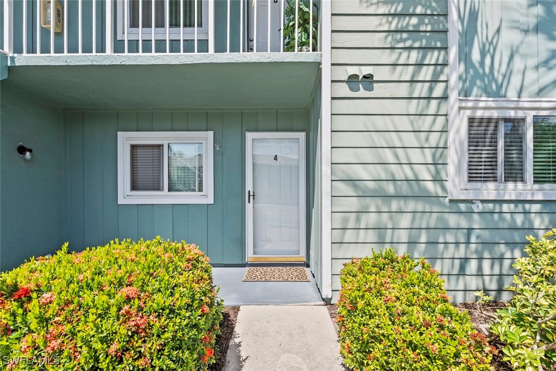 138 Cypress Way East, Unit 404 Naples, FL 34110 - Photo 3 of 32 a front view of a house