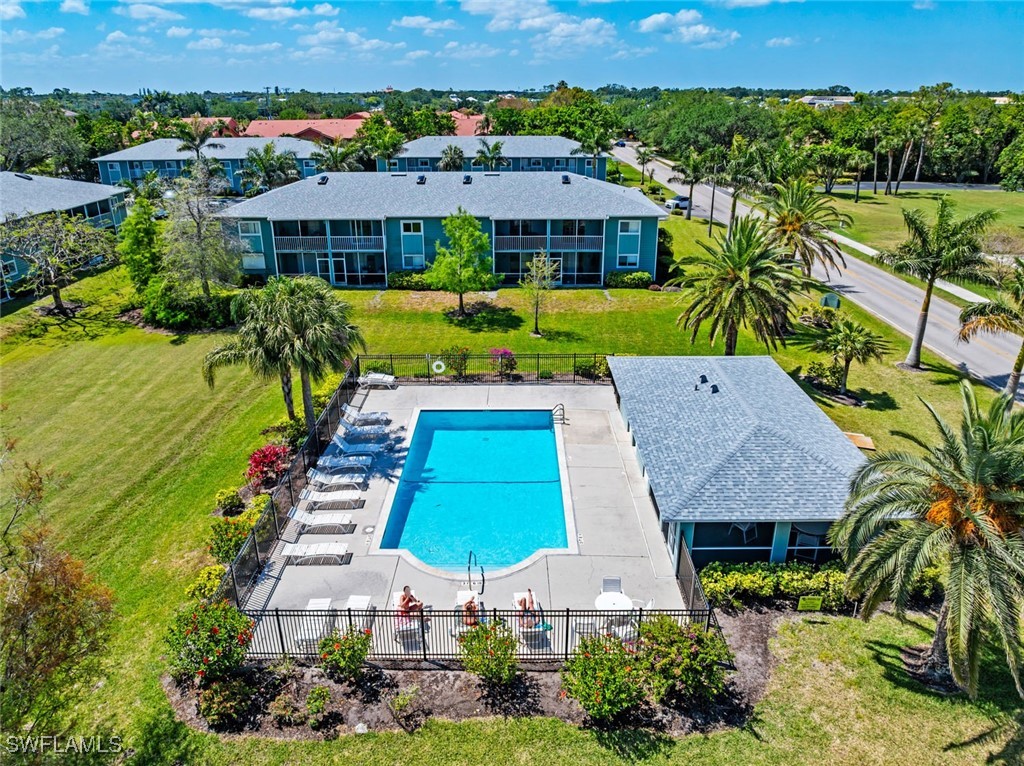 138 Cypress Way East, Unit 404 Naples, FL 34110 - Photo 31 of 32 an aerial view of multiple houses with yard