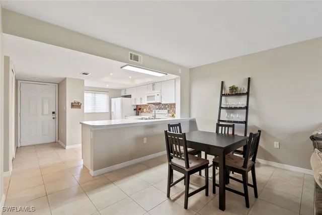 a kitchen with a table and chairs in it