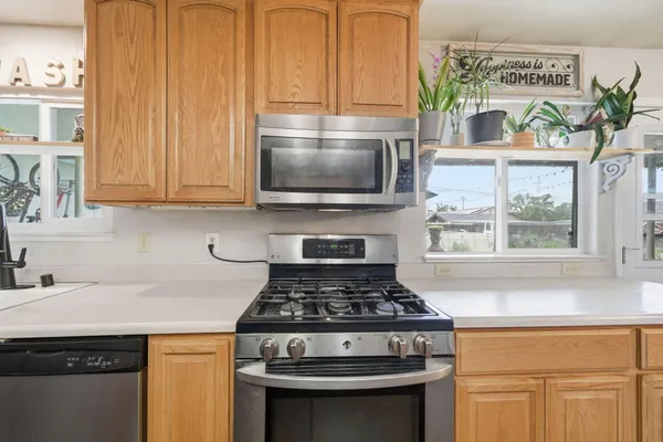 a stove top oven sitting inside of a kitchen