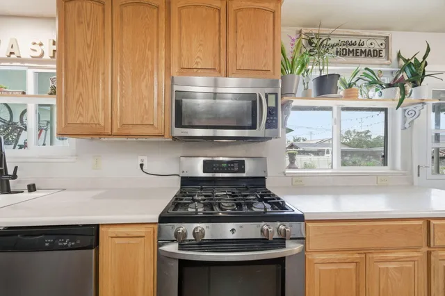 a stove top oven sitting inside of a kitchen