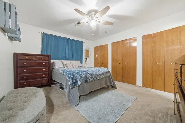 a bedroom with a bed and a dresser