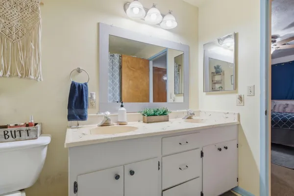 a bathroom with a double vanity sink and a mirror