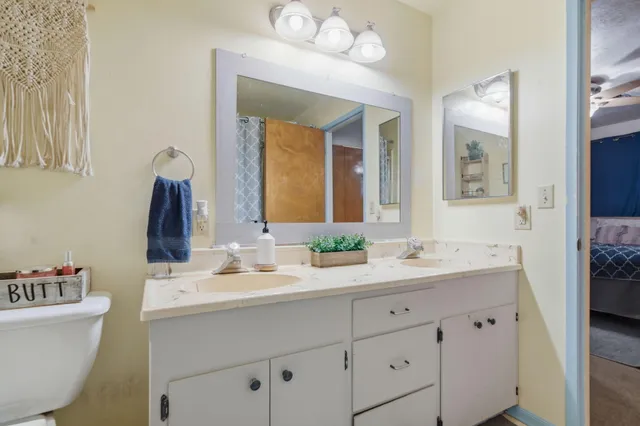 a bathroom with a double vanity sink and a mirror