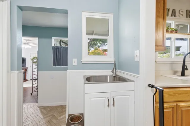 a kitchen with a granite countertop sink and a refrigerator
