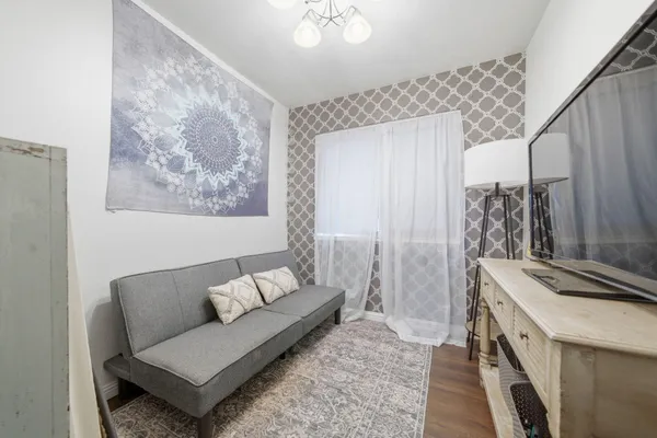 a living room with furniture and a dresser