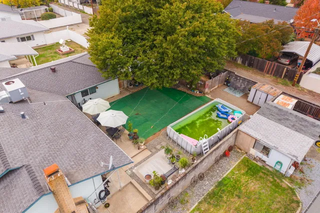 an aerial view of a house with a swimming pool