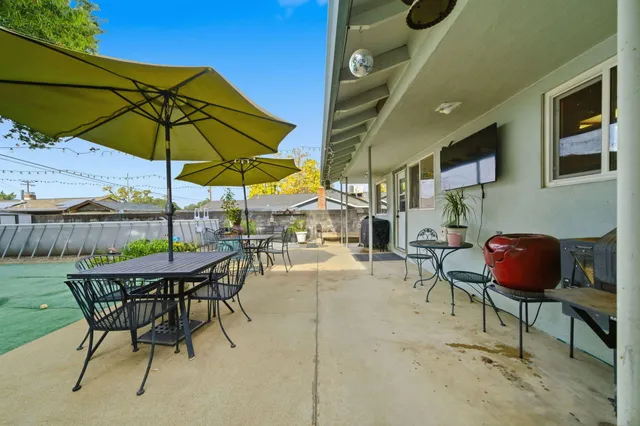a patio with a table and chairs
