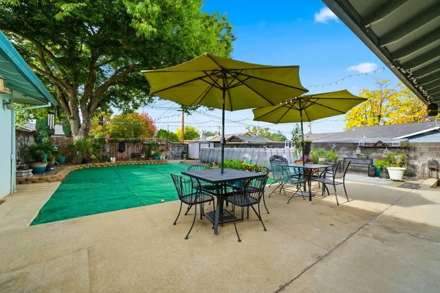 a view of a table and chairs under an umbrella
