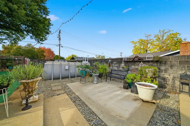 a view of a backyard with sitting area