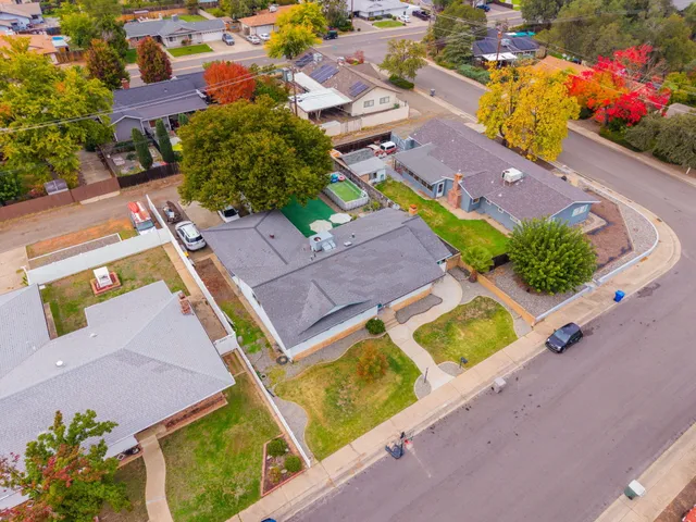 an aerial view of residential houses with yard and swimming pool