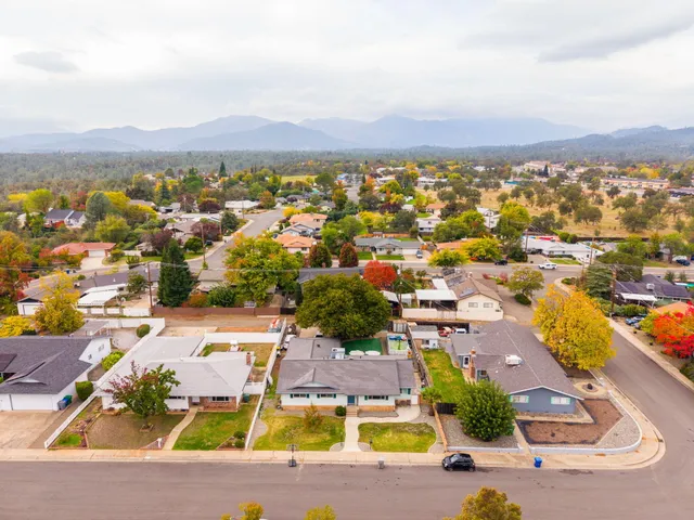 an aerial view of residential houses with outdoor space