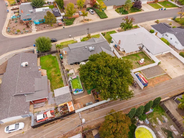 an aerial view of a house a yard and a swimming pool