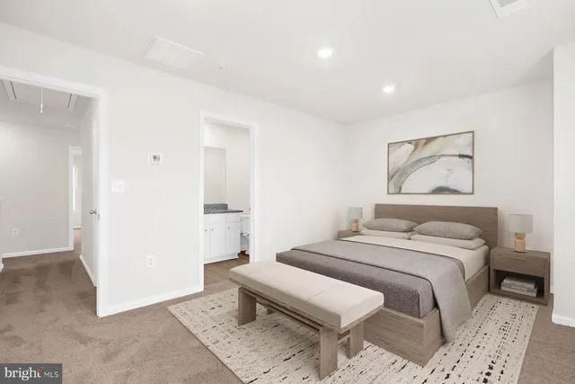 a bedroom with a bed and a painting