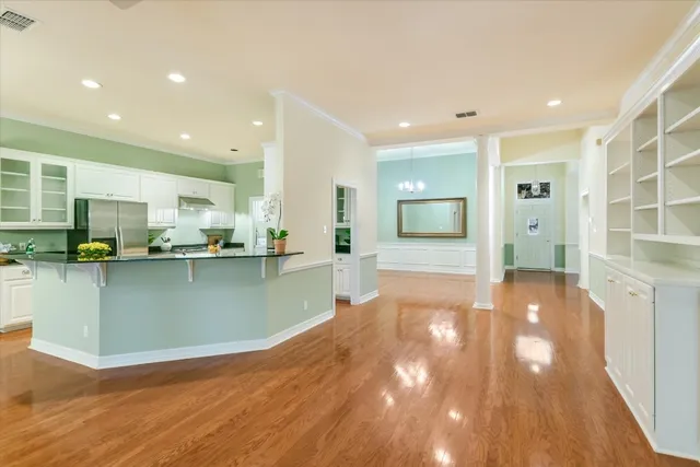 a view of a kitchen with kitchen island a sink stainless steel appliances and cabinets
