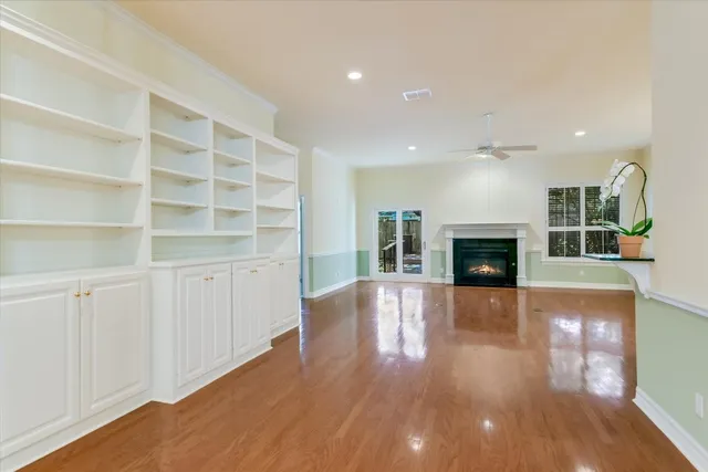 a view of empty room with wooden floor and fireplace