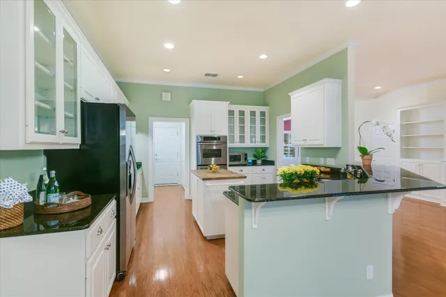 a kitchen with sink refrigerator and cabinets