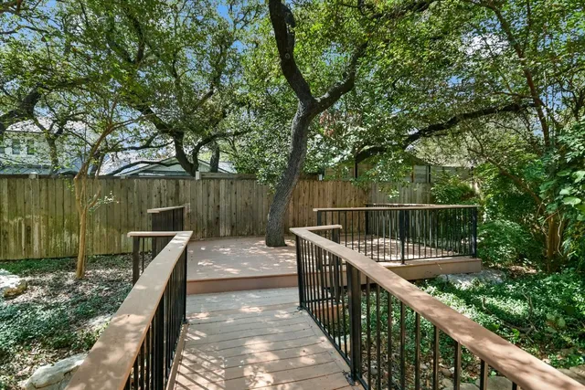 a view of balcony with wooden floor and fence
