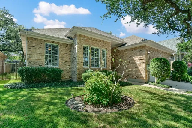 a view of a big house with a big yard and large tree
