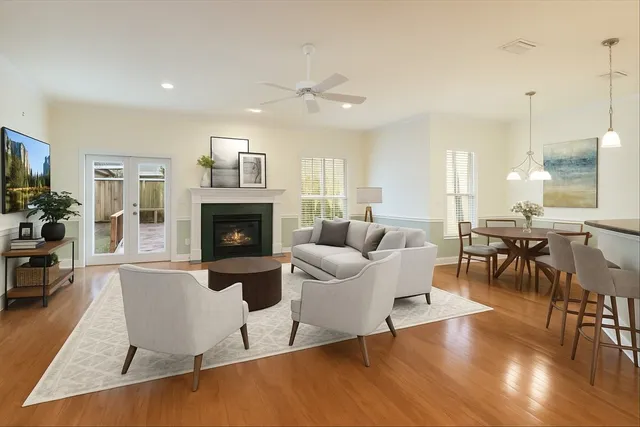 a living room with furniture wooden floor and a fireplace