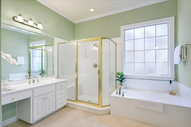 a spacious bathroom with a double vanity sink a large mirror a bathtub and shower