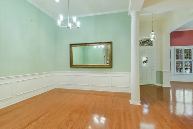 a view of a room with wooden floor and staircase