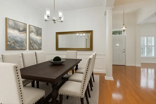 a view of a dining room with furniture and wooden floor