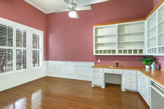 a room with a wooden floor and cabinets