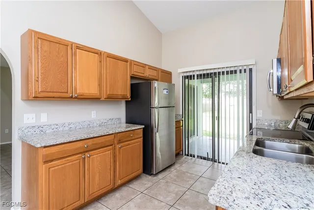 a kitchen with stainless steel appliances granite countertop a refrigerator and a sink