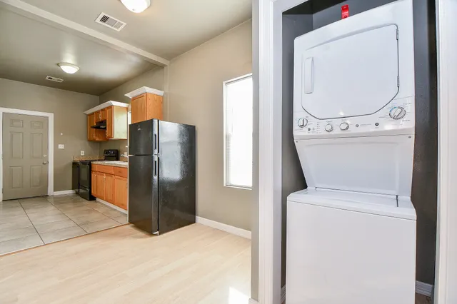a kitchen with a refrigerator sink and cabinets