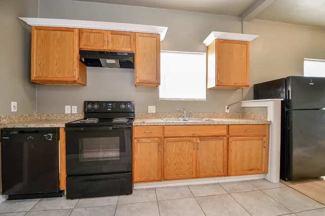 a kitchen with stainless steel appliances granite countertop a sink and a stove