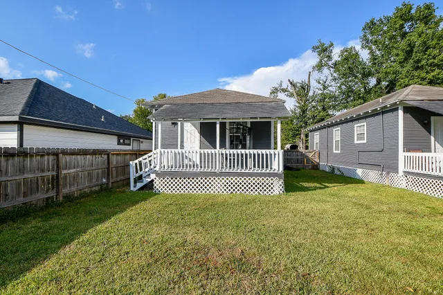 a view of a house with a backyard and porch