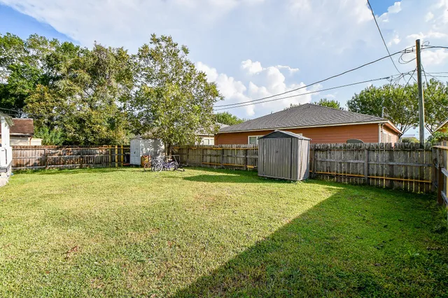 a view of a house with a yard and sitting area