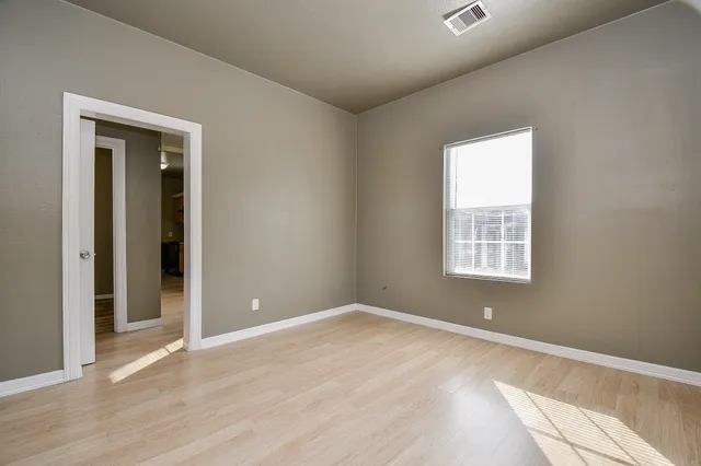 an empty room with window and closet