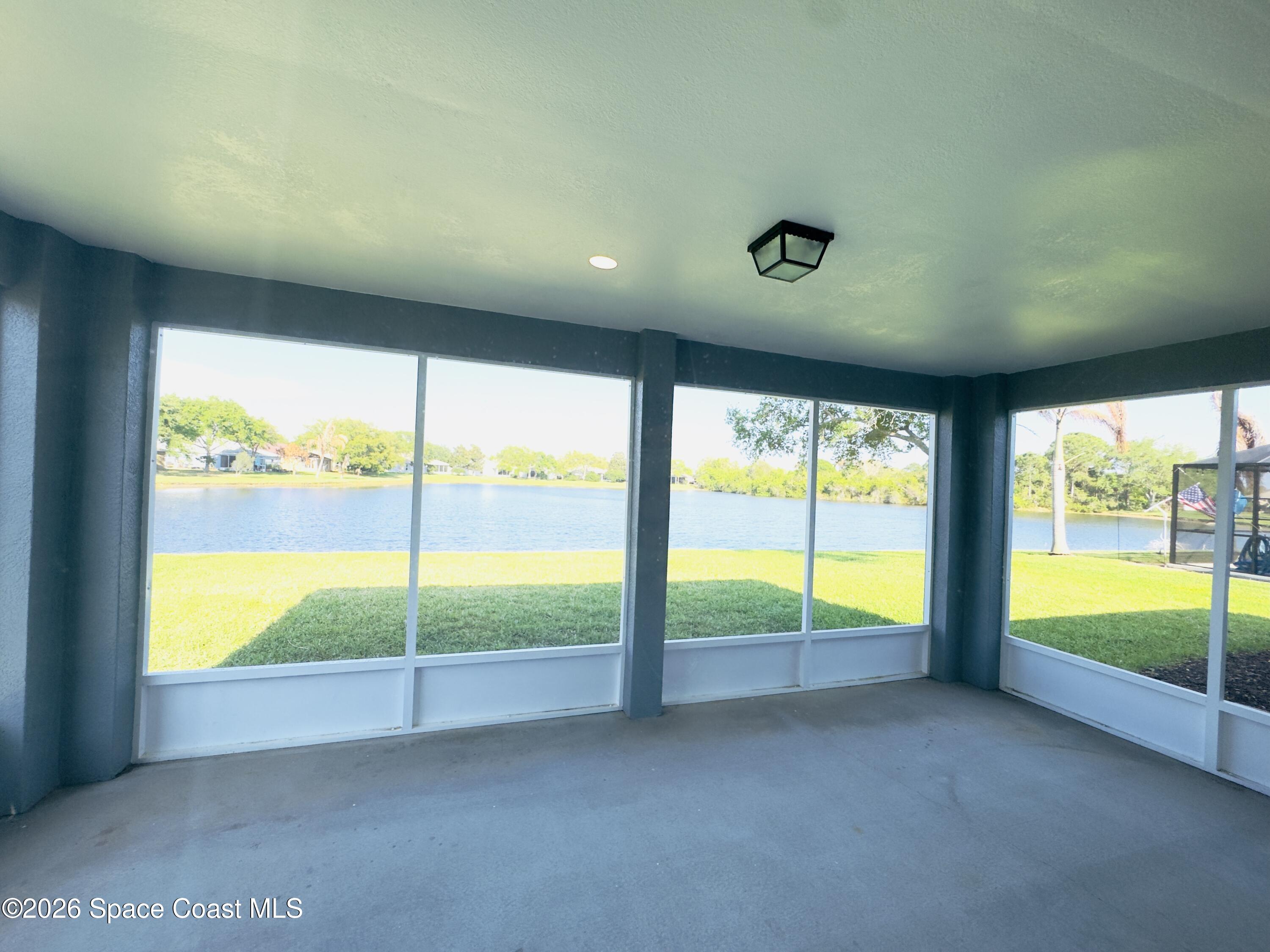 4691 Manchester Drive Rockledge, FL 32955 - Photo 4 of 4 a view of an empty room with a large window with an ocean view