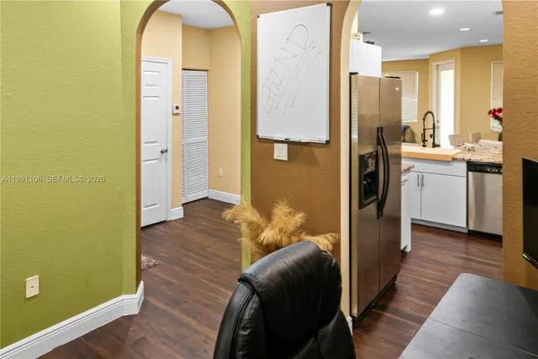 a kitchen with stainless steel appliances granite countertop a refrigerator and a stove