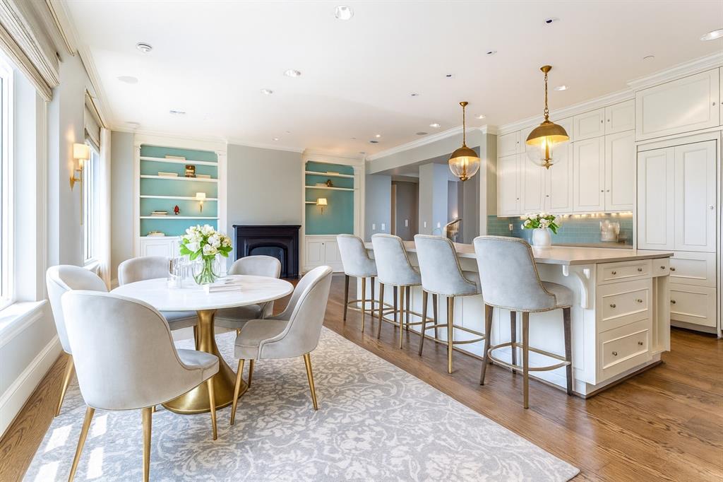 a dining room with furniture a chandelier and wooden floor