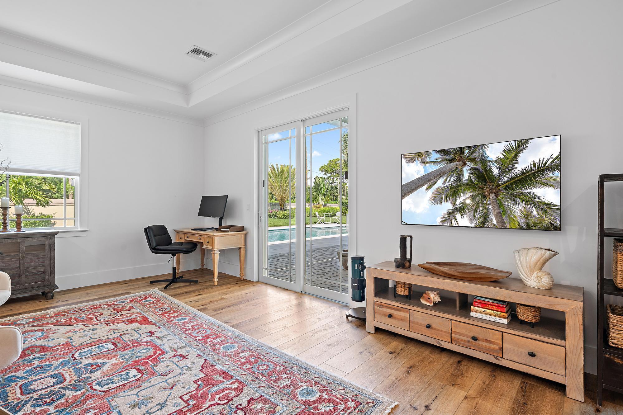 19993 Loxahatchee Pointe Drive Jupiter, FL 33458 - Photo 16 of 42 a living room with furniture and a flat screen tv